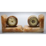 A pair of 1930's marble book-ends, one incorporates an aneroid barometer, the other a timepiece,