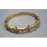 A late Victorian 9ct gold hinged bangle, gross 9.1 grams, with engraved initials.