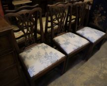 A set of three George III mahogany dining chairs with crewel-work seats and another set of three