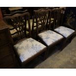 A set of three George III mahogany dining chairs with crewel-work seats and another set of three