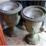 A pair of reconstituted stone garden urns, height 60cm