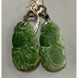 A pair of white and yellow metal, diamond chip set carved jade drop earrings, jade 35mm, gross 14.