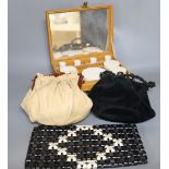 A 1960's plastic black and cream clutch bag, a black velvet bag and cream bag with Bakelite frame