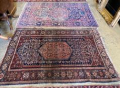 A Tabriz red and blue ground rug with pole medallion, 205 x 138 cm (worn) and a Fereghan rug with