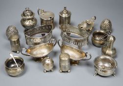 A collection of silver condiments, including a William IV foliate-embossed pepper by Edward,