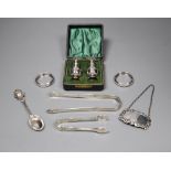 Small silver including a pair of Georgian sugar tongs, cased pepperettes, two napkin rings, spoon,