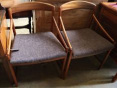 A set of four mid century Danish teak elbow chairs