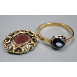 An early 20th century yellow metal (stamped 15) and banded agate set hinged bangle (repaired) and