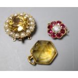 A yellow metal, ruby and diamond set flower head clasp, 12mm, a citrine and seed pearl set clasp and