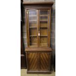 A late Victorian oak aesthetic movement bookcase cupboard, width 79cm depth 45cm height 216cm