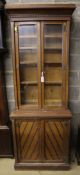 A late Victorian oak aesthetic movement bookcase cupboard, width 79cm depth 45cm height 216cm