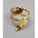 A Georgian style reeded yellow metal and gem set twin headed serpent ring, seed pear later added,