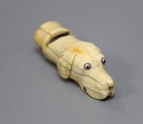 A Victorian ivory hound-head whistle, with glass inset eyes