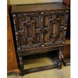 A 17th century and later oak cabinet of drawers enclosed by a pair of panelled doors, with