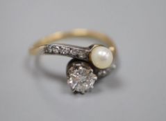 A yellow metal (stamped 18), diamond and cultured pearl set crossover ring, with diamond set