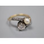 A yellow metal (stamped 18), diamond and cultured pearl set crossover ring, with diamond set