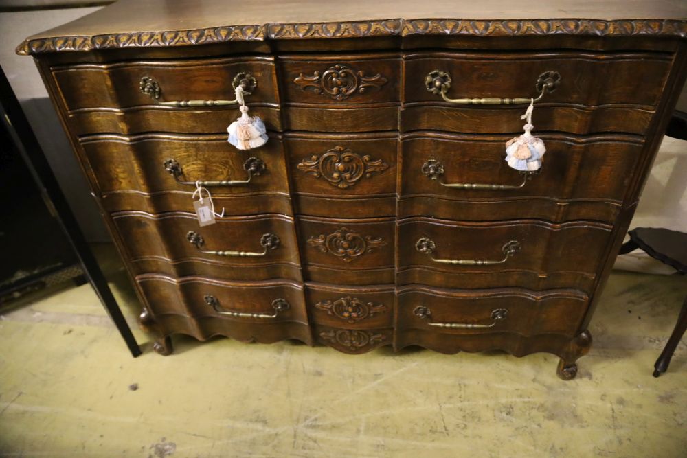 A 20th century French oak commode, fitted four long drawers with carved decoration, width 122cm, - Image 4 of 4