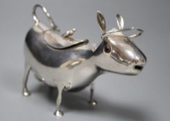 A mid 20th century Dutch white metal cow creamer, length 14cm, gross 145 grams.