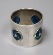 An Edwardian Art Nouveau silver and enamel napkin ring, William Hair Haseler, Birmingham, 1904,