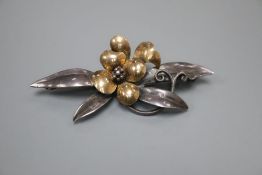 A continental 9ct and white metal (stamped silver) flower and leaf spray brooch, maker's mark B.I.?,