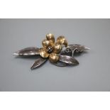 A continental 9ct and white metal (stamped silver) flower and leaf spray brooch, maker's mark B.I.?,