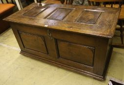 An 18th century panelled oak coffer, width 128cm, depth 61cm, height 64cm