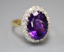 A 1970's 18ct gold, amethyst and diamond set oval cluster dress ring, size Q, gross 7.8 grams.