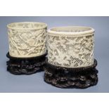 A pair of early 20th century Chinese ivory pots, with carved wood stands, overall height 16cm