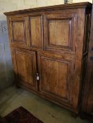 A 19th century French panelled walnut press cupboard fitted upper and lower pairs of doors, width