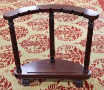 A mahogany sword stand, bow shape with reeded columns, claw feet, 92cm