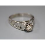 A diamond and 18ct white gold solitaire ring with pierced shank, size L/M, gross 2.9 grams.