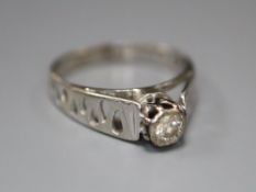 A diamond and 18ct white gold solitaire ring with pierced shank, size L/M, gross 2.9 grams.