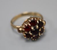 A 1960's 9ct gold and garnet cluster ring, size K/L, gross 3.2 grams.