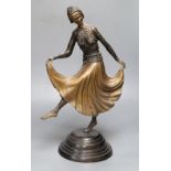 A patinated metal model of a 1930's dancer, on stepped circular base, 48cm