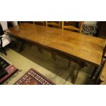 A 17th century style oak refectory table on X-frame supports, width 224cm, depth 70cm, height 74cm