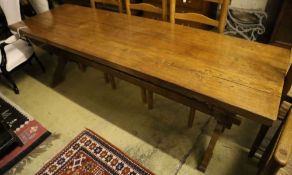 A 17th century style oak refectory table on X-frame supports, width 224cm, depth 70cm, height 74cm