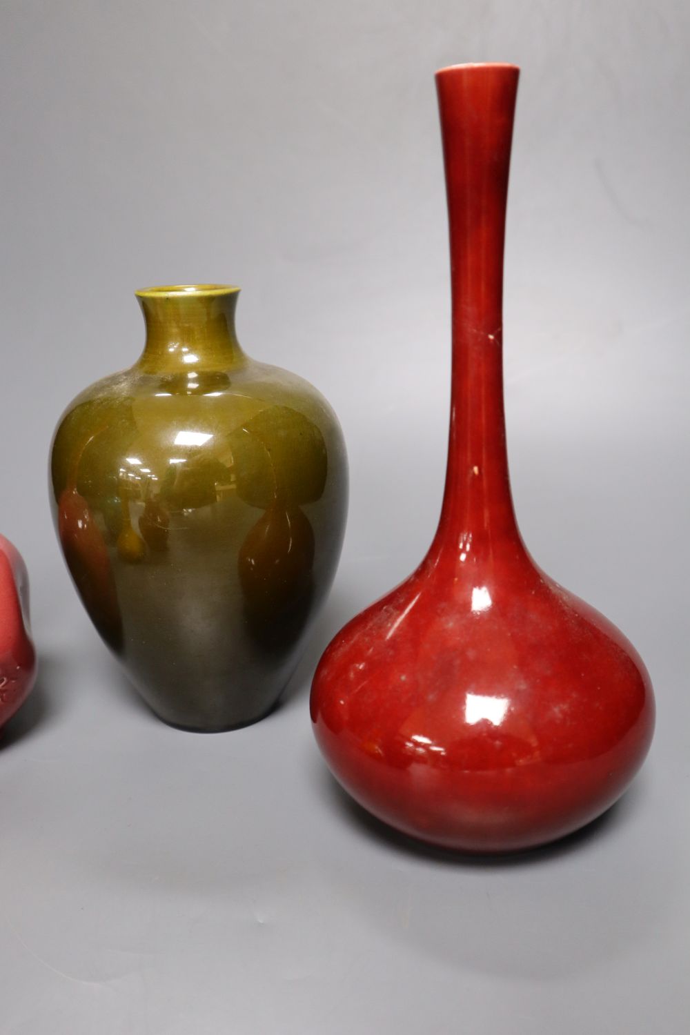 A collection of Burmantofts faience pottery vases, comprising a dark pink ground bottle-shaped - Image 5 of 7