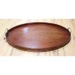 An oval wooden tray fitted brass handles, 62cm
