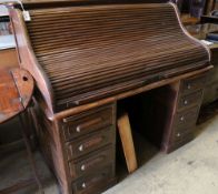 An oak roll-top desk, width 136cm, depth 86cm, height 126cm