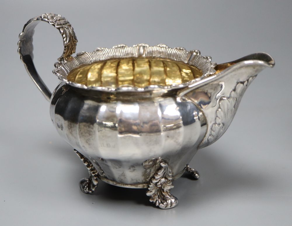 A George IV silver cream jug, London 1823 and an oval half-fluted tea caddy, William Hutton & Sons - Image 2 of 5
