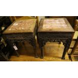 A pair of Chinese rectangular carved and pierced hardwood jardiniere stands with rouge marble