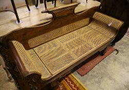 A colonial style caned hardwood scroll end settee, length 186cm, depth 62cm, maximum height 90cm