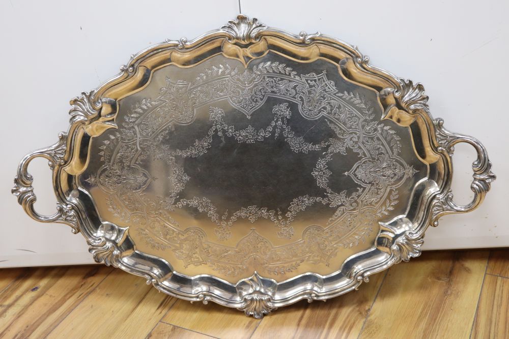 A large shaped oval silver two-handled tray with shell and scroll border, Edward Barnard & Sons,