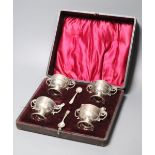 A cased set of four late Victorian silver salts, of two handled trophy cup form and matching spoons,