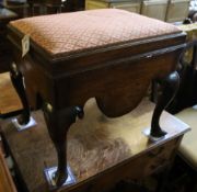 A George III mahogany box stool, the hinged lid with upholstered top above shaped apron and cabriole