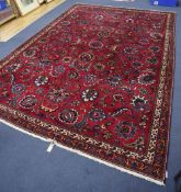 An Azerbaijan Tabriz rug having stylised foliate design on a claret field with two-row border and