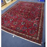 An Azerbaijan Tabriz rug having stylised foliate design on a claret field with two-row border and