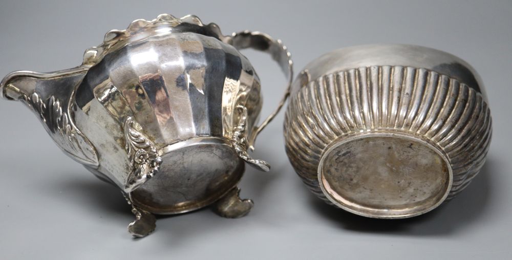 A George IV silver cream jug, London 1823 and an oval half-fluted tea caddy, William Hutton & Sons - Image 4 of 5