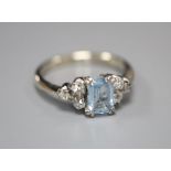 An 18ct white metal, aquamarine and diamond cluster dress ring, size P/Q, gross 3.7 grams.