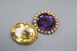 An Edwardian yellow metal, amethyst and split pearl set oval pendant brooch, 30mm and a similar
